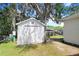 Exterior of shed, provides ample outdoor storage on a well-maintained lawn at 93 Bream St, Haines City, FL 33844