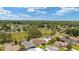Scenic aerial view of the community with a sprawling green space, mature trees and homes nestled in a verdant landscape at 1032 Kelsea Cir, The Villages, FL 32159