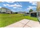 Expansive backyard featuring a well-maintained lawn and a screened-in patio area at 1032 Kelsea Cir, The Villages, FL 32159