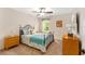 Cozy bedroom featuring a ceiling fan, comfortable furniture, and natural light from a window at 1032 Kelsea Cir, The Villages, FL 32159