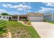 Charming single-story home with a two-car garage, well-maintained landscaping, and inviting curb appeal on a sunny day at 1032 Kelsea Cir, The Villages, FL 32159