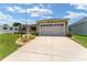 Charming single-story home featuring a two-car garage and a well-manicured lawn with mature landscaping at 1032 Kelsea Cir, The Villages, FL 32159