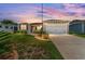 Charming single-story home featuring a well-manicured lawn and an attached two-car garage at 1032 Kelsea Cir, The Villages, FL 32159