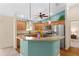 Charming kitchen with stainless steel appliances, granite counters, and bright lighting at 1032 Kelsea Cir, The Villages, FL 32159
