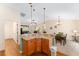 An open-concept kitchen offers stainless steel appliances and a cozy dining area at 1032 Kelsea Cir, The Villages, FL 32159
