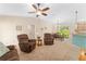 Comfortable living room with neutral carpeting, ceiling fan, and open access to the dining area at 1032 Kelsea Cir, The Villages, FL 32159
