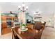 Open-concept living and dining area leading to a modern kitchen with stainless steel appliances at 1032 Kelsea Cir, The Villages, FL 32159
