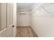 Spacious walk-in closet with shelving for ample storage at 1032 Kelsea Cir, The Villages, FL 32159