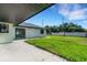 Outdoor living space featuring a spacious patio and well-maintained backyard at 2151 Groveglen S Ln, Lakeland, FL 33813