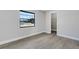 Bedroom featuring new gray wood-look flooring with view out a large window at 2151 Groveglen S Ln, Lakeland, FL 33813
