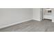 Bedroom featuring new gray wood-look flooring adjacent to the bathroom at 2151 Groveglen S Ln, Lakeland, FL 33813