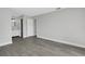Bedroom featuring new gray wood-look flooring with bathroom access at 2151 Groveglen S Ln, Lakeland, FL 33813