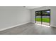 Bedroom with sliding glass doors and stylish gray wood-look flooring at 2151 Groveglen S Ln, Lakeland, FL 33813