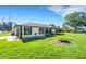 Well-maintained home showcasing a lush lawn and convenient attached garage at 2151 Groveglen S Ln, Lakeland, FL 33813