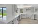 Modern kitchen boasts white cabinets, countertops, and updated appliances at 2151 Groveglen S Ln, Lakeland, FL 33813