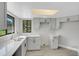 Bright kitchen features gray cabinets, stainless sink, and a skylight for natural lighting at 2151 Groveglen S Ln, Lakeland, FL 33813
