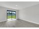 Bright living room with sliding glass doors and stylish gray wood-look flooring at 2151 Groveglen S Ln, Lakeland, FL 33813
