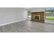 Cozy living room featuring a brick fireplace and ample natural light at 2151 Groveglen S Ln, Lakeland, FL 33813