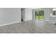 Open living space with updated flooring and a view of the backyard at 2151 Groveglen S Ln, Lakeland, FL 33813