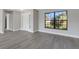 Open-concept room showcases a new front door and luxury vinyl plank flooring throughout at 2151 Groveglen S Ln, Lakeland, FL 33813