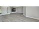 Bright living room with white walls, new flooring, and natural light, showcasing the home's entrance at 2151 Groveglen S Ln, Lakeland, FL 33813