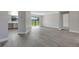 Spacious living area with new luxury vinyl plank flooring, adjacent to the modern kitchen at 2151 Groveglen S Ln, Lakeland, FL 33813