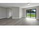 Bright room featuring new vinyl plank flooring and sliding glass doors to the backyard at 2151 Groveglen S Ln, Lakeland, FL 33813
