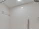 Shower featuring white tile with grab bar and shower head at 2151 Groveglen S Ln, Lakeland, FL 33813