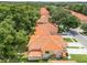 An aerial view showcases the townhome community, with its vibrant tile roofs and well-manicured lawns at 2256 Wekiva Village Ln, Apopka, FL 32703