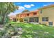 Lush backyard features a screened-in lanai and is surrounded by mature trees and landscaping at 2256 Wekiva Village Ln, Apopka, FL 32703