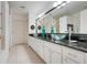 Bright bathroom features dual glass vessel sinks, a dark granite countertop and stylish modern fixtures at 2256 Wekiva Village Ln, Apopka, FL 32703
