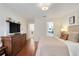 Comfortable bedroom featuring hardwood floors, a dresser, and a view of an ensuite at 2256 Wekiva Village Ln, Apopka, FL 32703