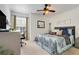 Comfortable bedroom featuring a ceiling fan, soft carpeting, and a bright window view at 2256 Wekiva Village Ln, Apopka, FL 32703