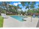 Relaxing community pool surrounded by lounge chairs and a brick wall at 2256 Wekiva Village Ln, Apopka, FL 32703
