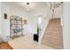Welcoming foyer with tiled floors, a staircase, and decorative furniture at 2256 Wekiva Village Ln, Apopka, FL 32703