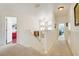 Bright hallway with carpet floors provides access to the upper-level rooms and living spaces at 2256 Wekiva Village Ln, Apopka, FL 32703