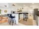 Modern kitchen with white cabinetry, black countertops, a breakfast bar, and an open view to the living room at 2256 Wekiva Village Ln, Apopka, FL 32703