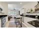 Bright kitchen with white cabinetry, granite countertops, and a view of the living area at 2256 Wekiva Village Ln, Apopka, FL 32703
