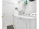 Functional laundry room with modern washer and dryer units and shelving at 2256 Wekiva Village Ln, Apopka, FL 32703