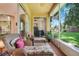 Relaxing screened porch with wicker furniture and views of the private backyard at 2256 Wekiva Village Ln, Apopka, FL 32703