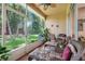 Inviting screened porch with comfortable seating overlooking a lush backyard at 2256 Wekiva Village Ln, Apopka, FL 32703