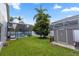 Lush backyard featuring a pool with screened enclosure and shed at 2423 Turnberry Dr, Oviedo, FL 32765