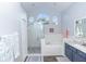 Bright bathroom featuring a soaking tub, glass shower, and large arched windows at 2423 Turnberry Dr, Oviedo, FL 32765