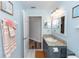 Well-lit bathroom features blue walls, granite counters, and decorative wall art at 2423 Turnberry Dr, Oviedo, FL 32765
