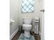 Clean half-bathroom featuring toilet and storage at 2423 Turnberry Dr, Oviedo, FL 32765