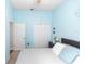 Comfortable bedroom features a cozy bed, soothing blue walls and natural light at 2423 Turnberry Dr, Oviedo, FL 32765