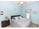 Bedroom features a queen bed, ceiling fan, and light-filled window at 2423 Turnberry Dr, Oviedo, FL 32765