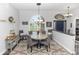 Bright dining room featuring an arched window, stylish furnishings, and an elegant chandelier, perfect for gatherings at 2423 Turnberry Dr, Oviedo, FL 32765
