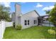 Exterior view of the house highlighting screened pool, yard, and architectural details at 2423 Turnberry Dr, Oviedo, FL 32765
