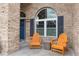 Inviting front porch features a brick facade, arched windows, and comfortable seating, perfect for relaxing at 2423 Turnberry Dr, Oviedo, FL 32765